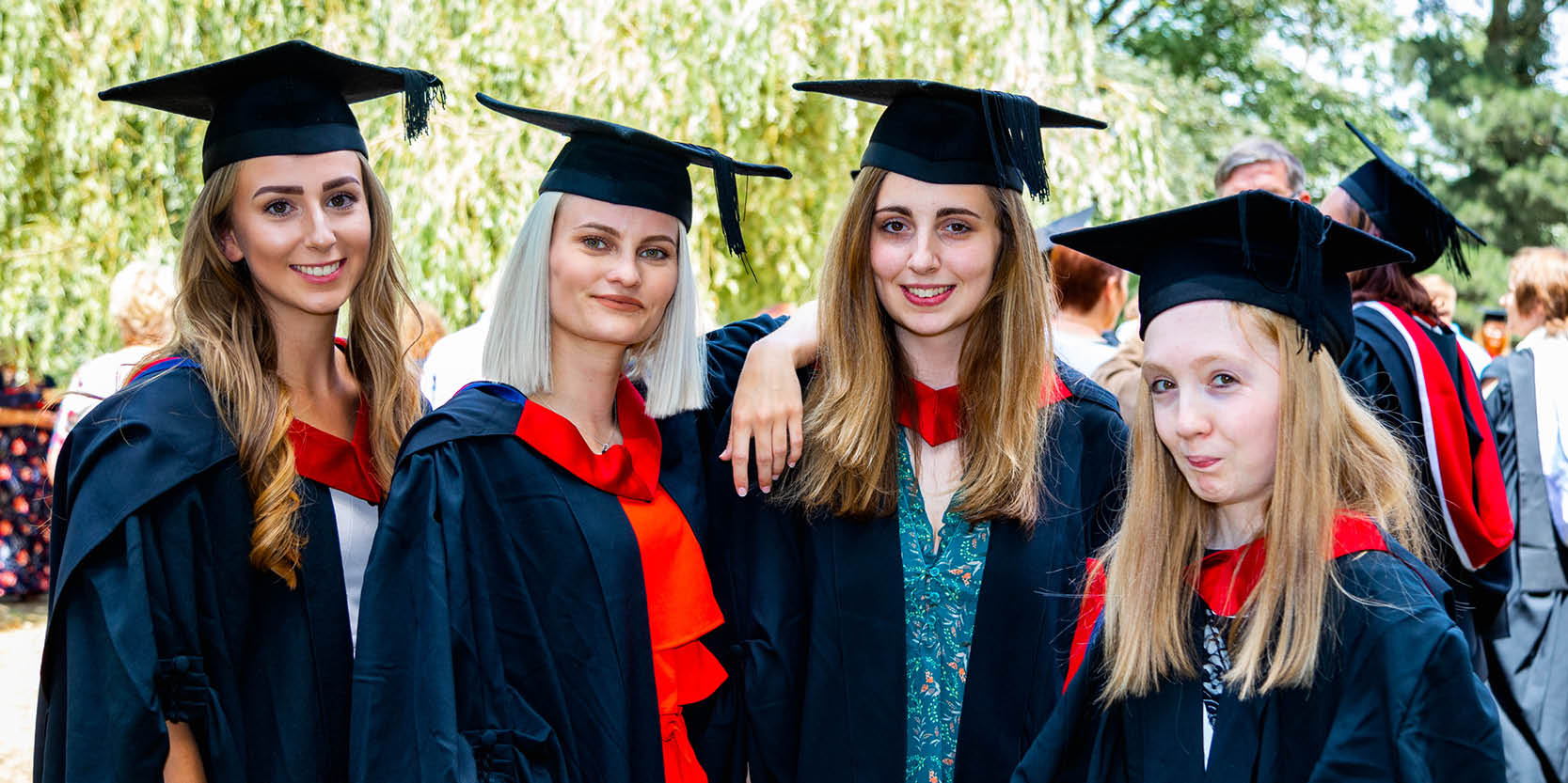 A group of friends pose for a graduation picture