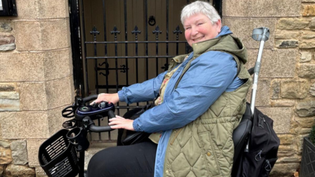 Former dog grooming student, Joanne, in her mobility scooter.
