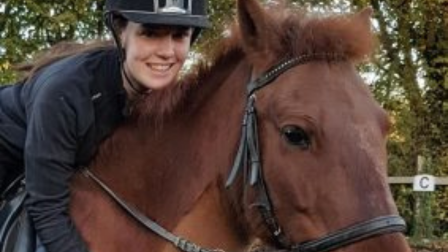 Sophie riding a chestnut horse