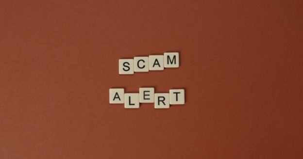 orange background with scam alert written on it