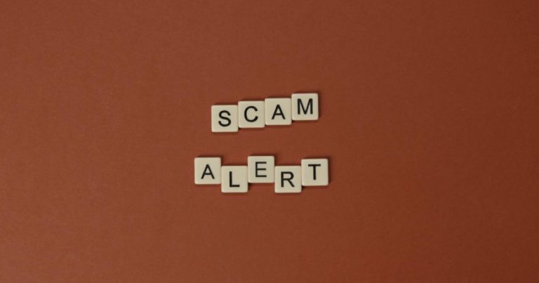 orange background with scam alert written on it