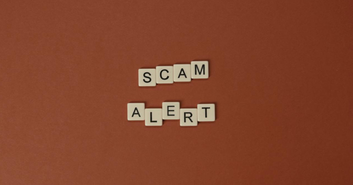 orange background with scam alert written on it